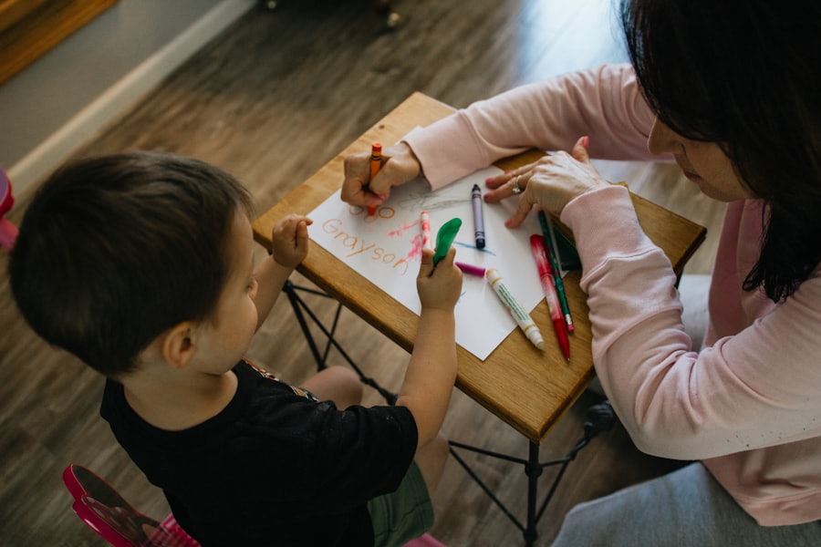 An adult and toddler drawing with markers together