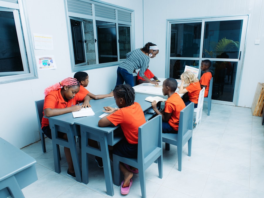 Children learning at tables with a teacher in a classroom