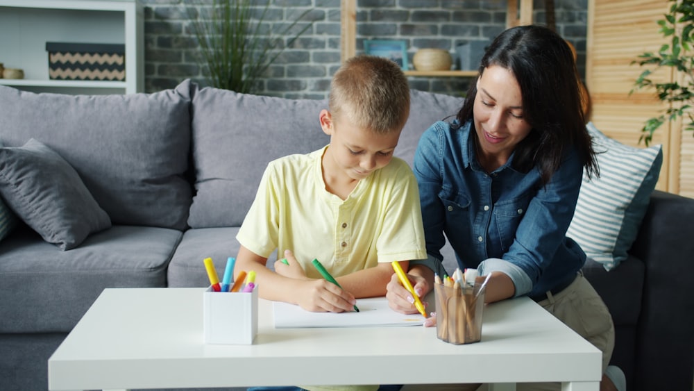 A parent and child smiling while drawing together